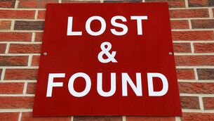<p>Red lost and found sign on brick wall.</p>