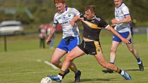 <p>Dylam Prendergast, seen in action against Hollynount-Carramore's Oisin Duffy during the group stages, secured Louisburgh's place in the intermediate championship with an outrageously risky score that has relegated Burrishoole to junior football.	Picture: Conor McKeown</p>
