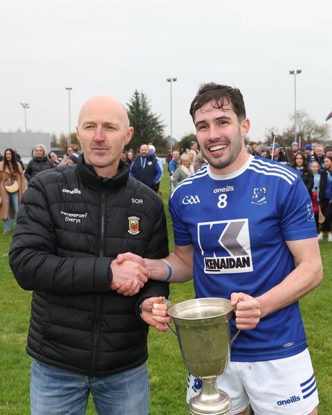  Sean Ó Raghallaigh, Mayo GAA Hurling Committee chairperson, presents the TJ Tyrell Cup to Danny Huane captain of Tooreen.
