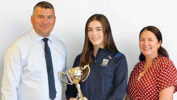 Congratulations to Madison Murphy, winner of this year’s Ailbhe Ní Ghearbháin Memorial Cup at Gaelcholáiste Chomáin. Madison achieved the highest results in the 2025 Leaving Certificate examinations and is now pursuing her dream of studying Medicine at UCD. Pictured with College Principal Mark Irwin and Deputy Principal Collette Wilson. Congratulations to Madison Murphy, winner of this year’s Ailbhe Ní Ghearbháin Memorial Cup at Gaelcholáiste Chomáin. Madison achieved the highest results in the 2025 Leaving Certificate examinations and is now pursuing her dream of studying Medicine at UCD. Pictured with College Principal Mark Irwin and Deputy Principal Collette Wilson.