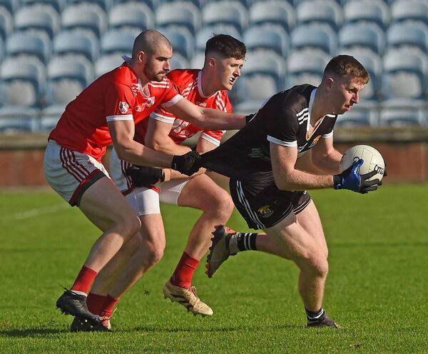 Kilmeena's Caolach Halligan is closely marked by Tadhg Ruane and Ryan Kenny of Moy Davitts.	Picture: Conor McKeown