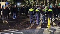 Fireworks launched at gardaí in clash with protesters at Citywest
