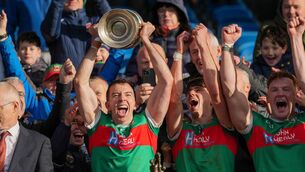 <p>Evan Regan of Ballina Stephenites lifts the Moclair Cup after helping his side to a stunning recovery against Westport on Saturday afternoon.	Picture: INPHO/James Lawlor</p>