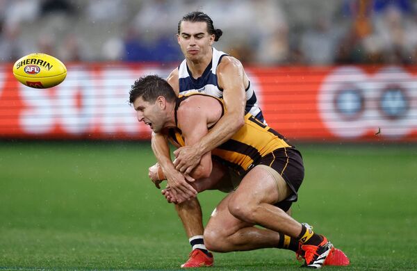Luke Breust of the Hawthorn Hawks is tackled by former Mayo footballer Oisin Mullin of the Geelong Cats at the Melbourne Cricket Ground.