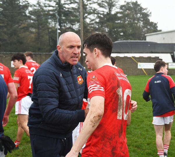 St Muredach's coach PJ Sweeney congratulates Oisin McCann at the full-time whistle. Picture: John O'Grady