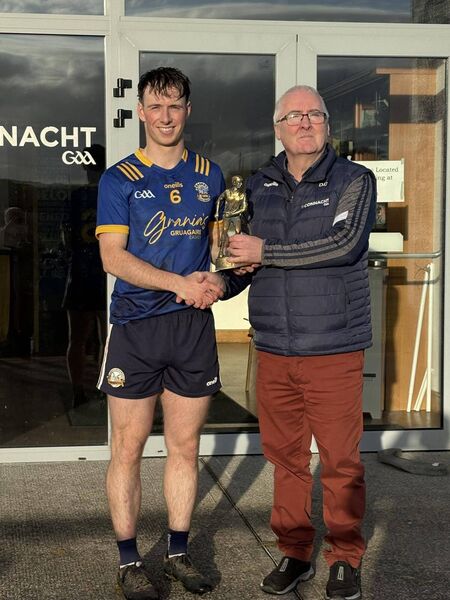 Rory McHugh receives his Player of the Match award from Dermot Gannon.