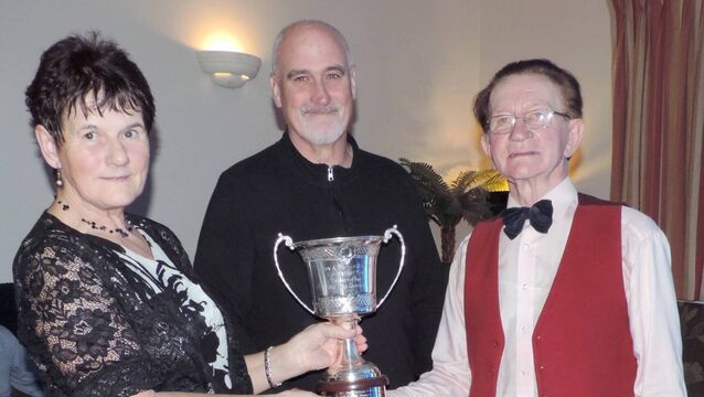 <p>At the Tony and Bernie Towey Dance competition in the Brusna Inn were Mary Small and Ronan Kelly (right) being presented with the Tony and Bernie Towey Perpetual Cup by Gerry Towey. Picture James Hunt Photography.</p>