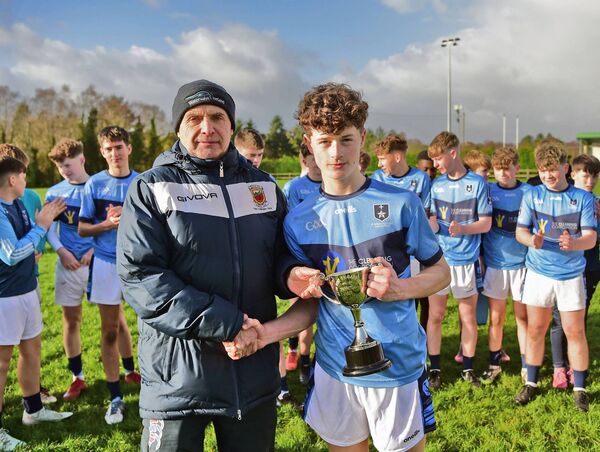 Joe McCabe from Connacht Schools GAA presents the Oâ'Haire Cup to St Gerald's Juvenile captain Conor Moran after their win over Rice College. 