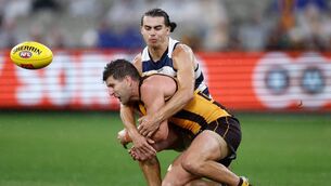 <p>Luke Breust of the Hawks is tackled by Oisin Mullin of the Geelong Cats at the Melbourne Cricket Ground in 2024. Mullin has spent the past couple of months training with the Mayo senior football team.	Picture: Michael Willson/AFL/Getty Images</p>