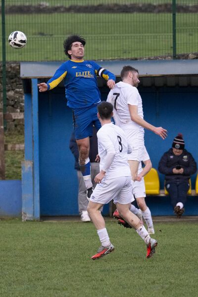 Roscommon captain Cathal Horan, who plays for Ballaghaderreen AFC but is well-known too for his GAA exploits with Kilmovee and Mayo, challenges Mayo’s Darragh Byrne in the air. Picture: John Corless