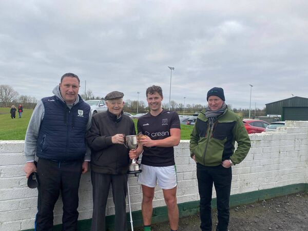 Michael Byrnes Senior presenting the Michael Byrnes Memorial Cup to victorious under 30s skipper Matt Lenehan following their victory over over 30s. Also pictured is club chairman Ryan O'Connor (left) and Damien McEntire.