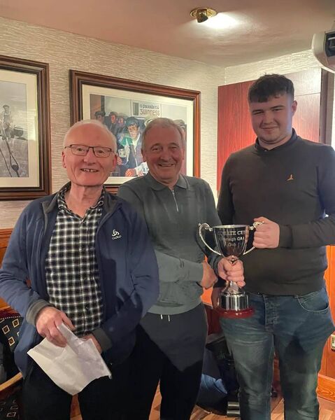 Kiltimagh GAA club president John Mallee presented the Coillte Cup to winning captain Tiernan Burke, of the Swinford/Bohola Road team, with club chairperson Gerry King also in attendance for the presentation.
