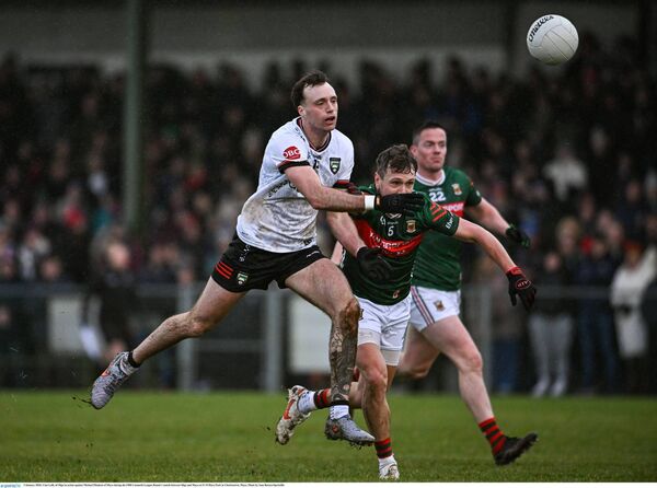 Cian Lally of Sligo is challenged by Mayo defender Michael Plunkett.