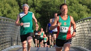 <p>Castlebar 5k women's race winner Colette Tuohy leads Evin McHale over Lough Lannagh bridge</p>