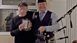 <p>Graham Mace (left) and Anthony Kelly, piper, at the Burns Night celebration in Kiltimagh. Graham is holding his prize for the Most Appropriate Contribution.</p>