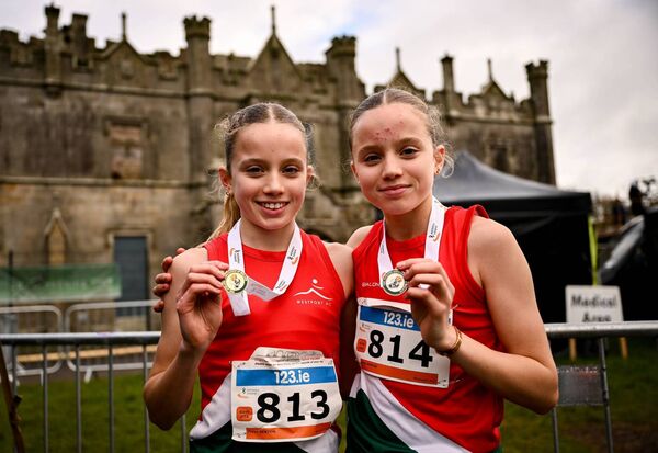 Twin sisters Freya Renton, left, and Holly Renton of Westport AC, with their respective gold and silver medals after the U16 4000m at the  National Cross Country Championships at Castle Irvine Estate in December 2024. The pair have knitted together success after success and Freya has smashed record after record. She is this year's recipient of the Young Sportsperson of the Year at the Western People Mayo Sports Stars.	Picture: Ramsey Cardy/Sportsfile