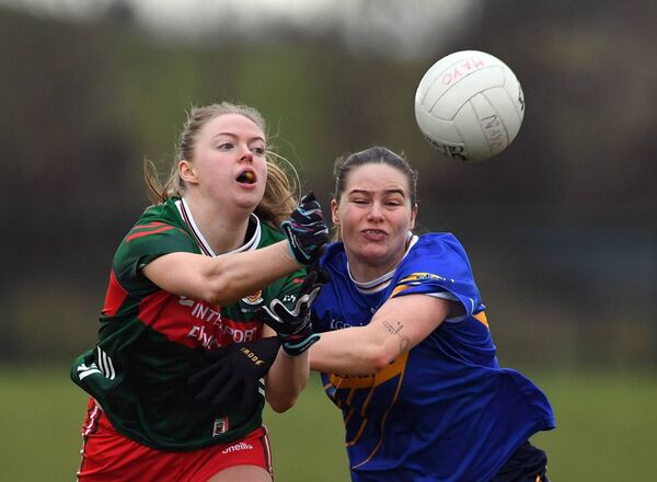 Hannah Reape offloads the ball despite the close challenge of Tipperary’s Maria Curley. 