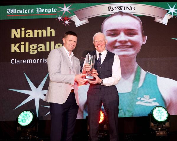 Padraic Kilgallen, father of rowing award winner Niamh, accepts her Mayo Sports Stars crystal from special guest Tomás Ó Sé. Picture: Michael Donnelly