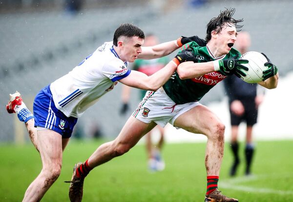 Mayo wing-back Sam Callinan is tackled by Monaghan midfielder Micheal McCarville.