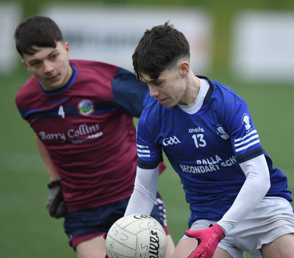 Balla’s Charlie Fallon on his way to scoring his side’s second goal despite the close marking of Carrigaline’s James Bryan during the All-Ireland PPS Senior 'C' football semi-final at Clarecastle last Saturday. Picture: David Farrell Photography 