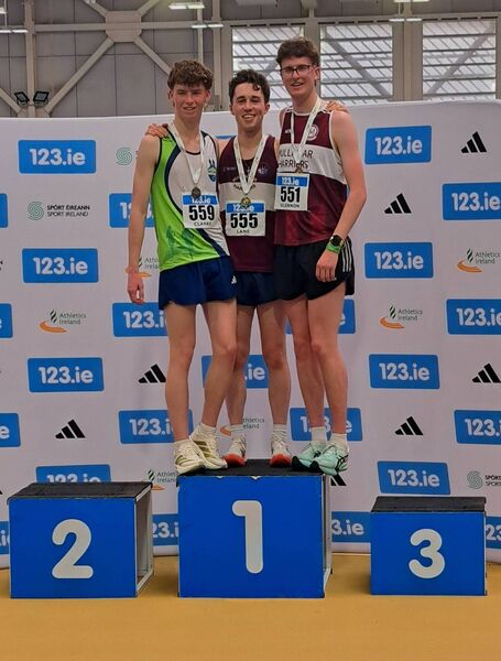 Seamus Clarke, left, with race winner Oisin Lane and Matthew Glennon, both of Mullingar Harriers.