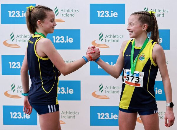Freya Renton, right, celebrates with her sister Holly after they finished first and fourth respectively in the inter girls event. Picture: Thomas Flinkow/Sportsfile