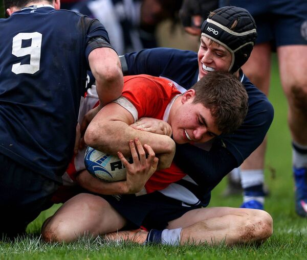 Oisin Breslin of St Muredfach's is held up by Sligo Grammar's Andrew Ryan and Matthew O'Grady. Picture: INPHO/Tom O’Hanlon
