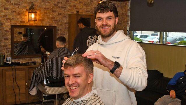 <p>Kevin Walsh of Kev's Kutz, Ballina, pictured here with customer Michael McDonnell, has been cutting hair since 6pm yesterday (March 15) as part of a 24-hour haircut marathon fundraiser for the Ballina Sensory Park</p>