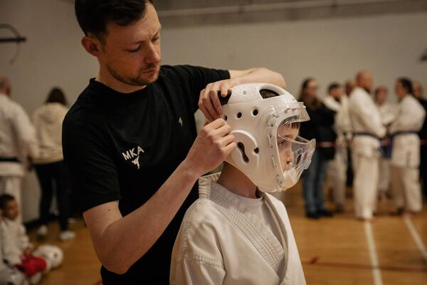 Mayo Karate Academy head coach Aaron McLoughlin assists student Sean Gilmartin, aged 9, ahead of his Kumite (sparring) match. Mayo Karate Academy head coach Aaron McLoughlin assists student Sean Gilmartin, aged 9, ahead of his Kumite (sparring) match.