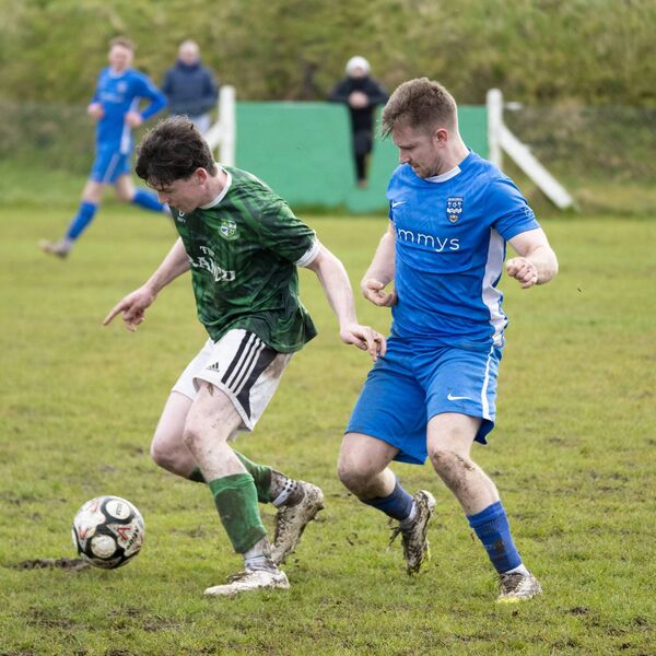 Claremorris midfielder James Morley shields the ball from Ballina Town’s Dylan McKee. 