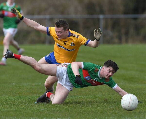 Ballina Stephenites Matthew Leonard collides with Knockmore’s Sean Holmes. 