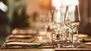 <p>Table setting with wine glasses.</p>
