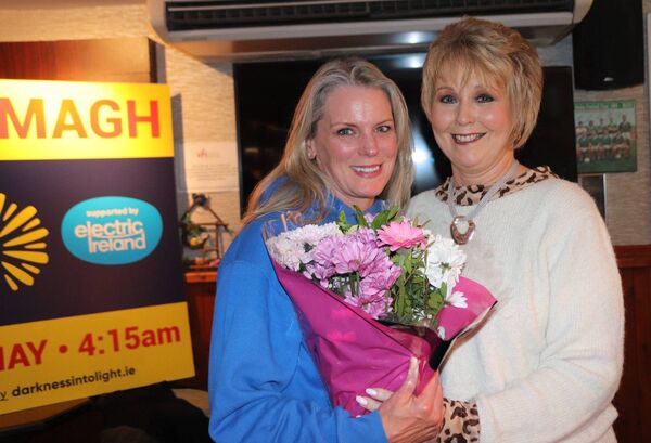 Guest speaker Geraldine Murphy (right) receives a presentation from Dominque Cosgrove, treasurer of Kiltimagh Darkness into Light.