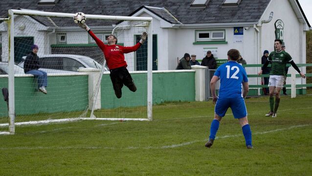 <p>Claremorris goalkeeper Peter Murphy saves from Jesse Devers (not in picture) with Ballina Town’s Jamie Moyles (12) ready if the ball rebounds. Picture: John Corless</p>