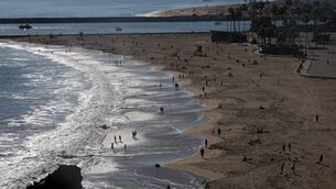 <p>People are seen along Corona del Mar State Beach in Newport Beach, California in 2020. Picture: Michael Heiman/Getty Images</p>