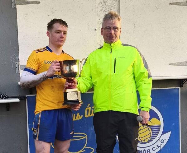 Declan O'Boyle presents the Sweeney Cup on behalf of the North Mayo GAA Board to Knockmore captain Sean Holmes.