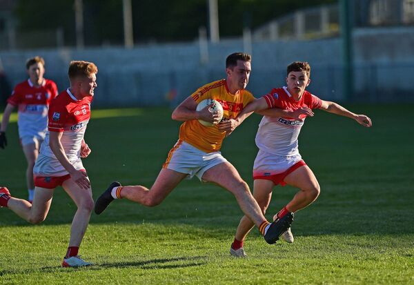 Castlebar's Conor Stenson holds off the challenge of Belmullet's. Picture: Conor McKeown Castlebar's Conor Stenson holds off the challenge of Belmullet's. Picture: Conor McKeown