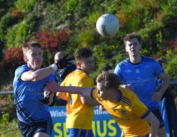 Westport’s Killian Kilkelly offloads the ball as Knockmore’s Martin Orme challenges. Pictures: David Farrell Photography Westport’s Killian Kilkelly offloads the ball as Knockmore’s Martin Orme challenges. Pictures: David Farrell Photography