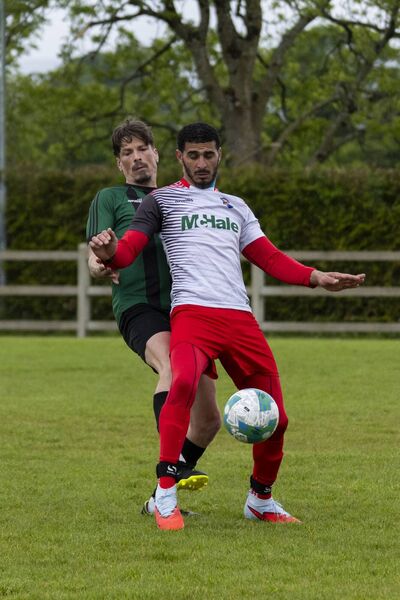 Chris Moore of Conn Rangers and Rodrigo Rosado de Costa of Ballinrobe Town. Chris Moore of Conn Rangers and Rodrigo Rosado de Costa of Ballinrobe Town.