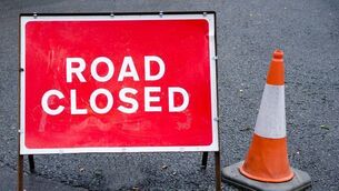 <p>Road closed sign with traffic cone,</p>