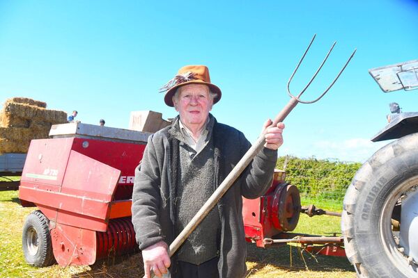 Frank Flannelly has been operating a thresher for over 50 years.