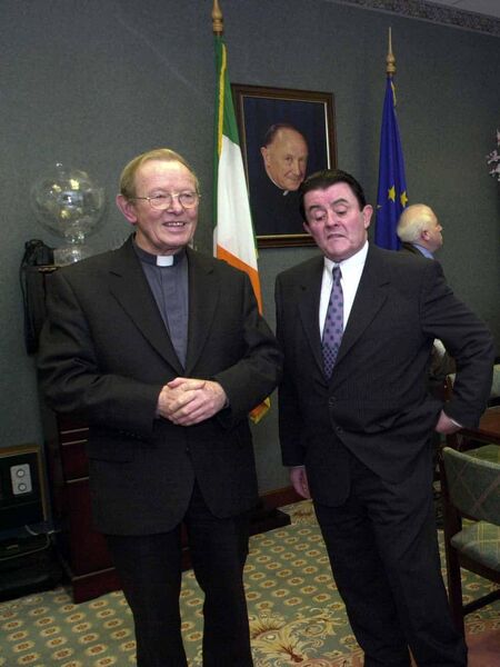 Monsignor Dominick Greally and Cathal Duffy in the boardroom under the watchful gaze of Monsignor Horan.