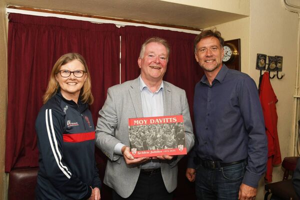 Moy Davitts club chairperson Willie Byrne and club secretary Bernie Ryder present a copy of the Moy Davitts history to Rory Conway, grandson of Pat Conway. Picture: John O'Grady Moy Davitts club chairperson Willie Byrne and club secretary Bernie Ryder present a copy of the Moy Davitts history to Rory Conway, grandson of Pat Conway. Picture: John O'Grady