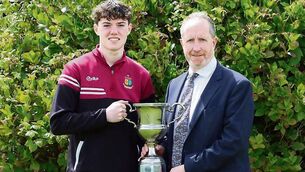 <p>Gavin McAndrew is pictured receiving the Gerard McNally Memorial Cup from principal Edmund Holmes.</p> <p>Gavin McAndrew is pictured receiving the Gerard McNally Memorial Cup from principal Edmund Holmes.</p>