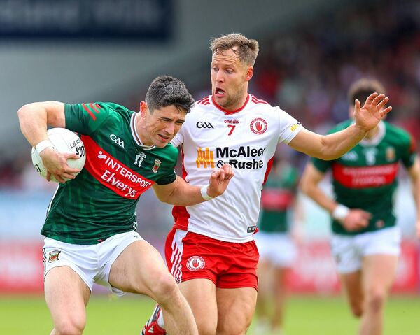 Mayo's Conor Loftus protects the ball from Kieran McGeary of Tyrone.