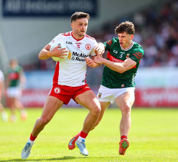 Tyrone's Michael McKernan comes under pressure from his opposite number Sam Callinan.