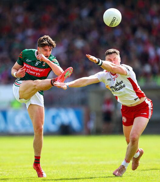 Sam Callinan has his kick blocked down by Peter Teague of Tyrone. Sam Callinan has his kick blocked down by Peter Teague of Tyrone.
