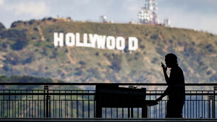 <p>A worker wheels equipment past the famous Hollywood sign as preparations continue on March 8, 2023, for the 95th Academy Awards, which took place against the backdrop of an industrial-wide strike. 	Picture: AP Photo/J. David Ake</p>