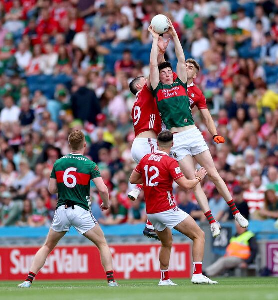Bob Tuohy of Mayo rises high to beat Cork’s Colm O'Callaghan and Ian Maguire to possession. Pictures: INPHO/James Crombie Bob Tuohy of Mayo rises high to beat Cork’s Colm O'Callaghan and Ian Maguire to possession. Pictures: INPHO/James Crombie