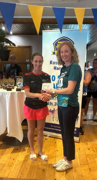 Mayo AC's Norah Newcombe Pieterse receives her second place prize from Michelle McNeela after the Roscommon Harriers 10 Miler.